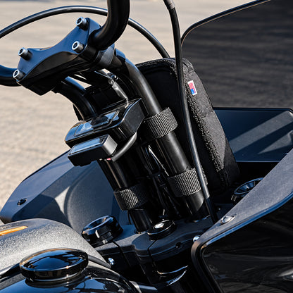 Black Moto Pockets Mini T-Bar motorcycle handlebar bag installed between tall handlebar risers, showing adjustable mounting straps and secure fit behind the handlebars.