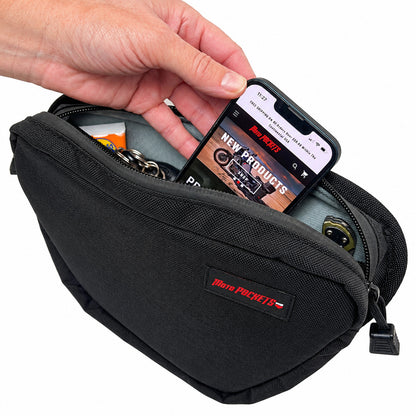 Moto Pockets OG T-Bar motorcycle handlebar bag open with a smartphone being placed inside, showing storage for keys and everyday riding essentials.